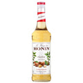 Monin Hasselnøtt sirup 70 cl i glassflaske med rød og hvit etikett, perfekt til kaffe og dessert.