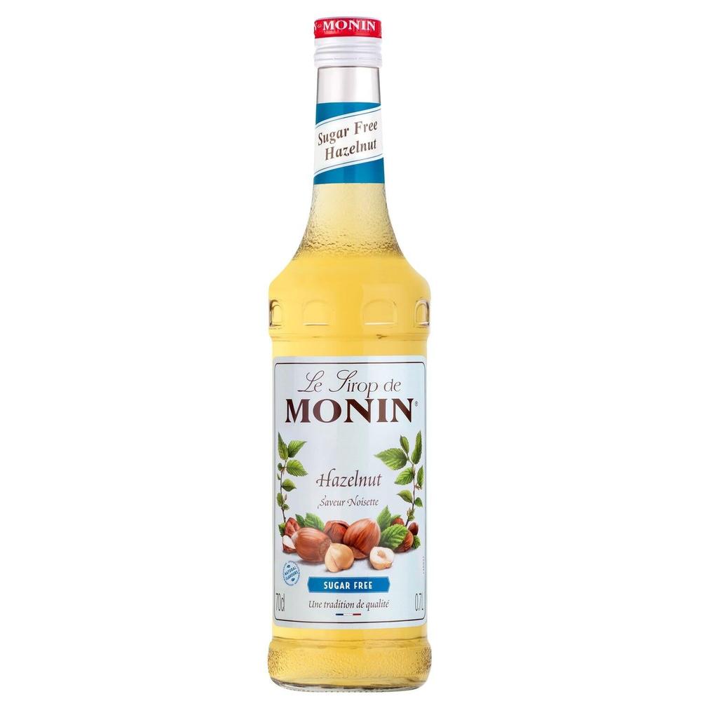Monin Sukkerfri Hasselnøttsirup 70 cl i glassflaske med hvit kork og blå etikett.