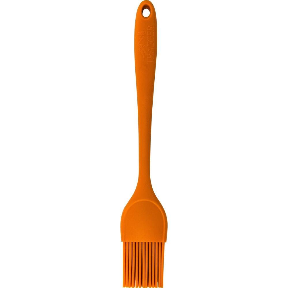 Oransje Traeger silikonpensel for marinader, varmebestandig og hygienisk med opphengsløkke.