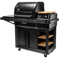 Traeger Timberline L pelletsgrill i svart med sidebord, induksjonstopp, skap og hyller i tre.